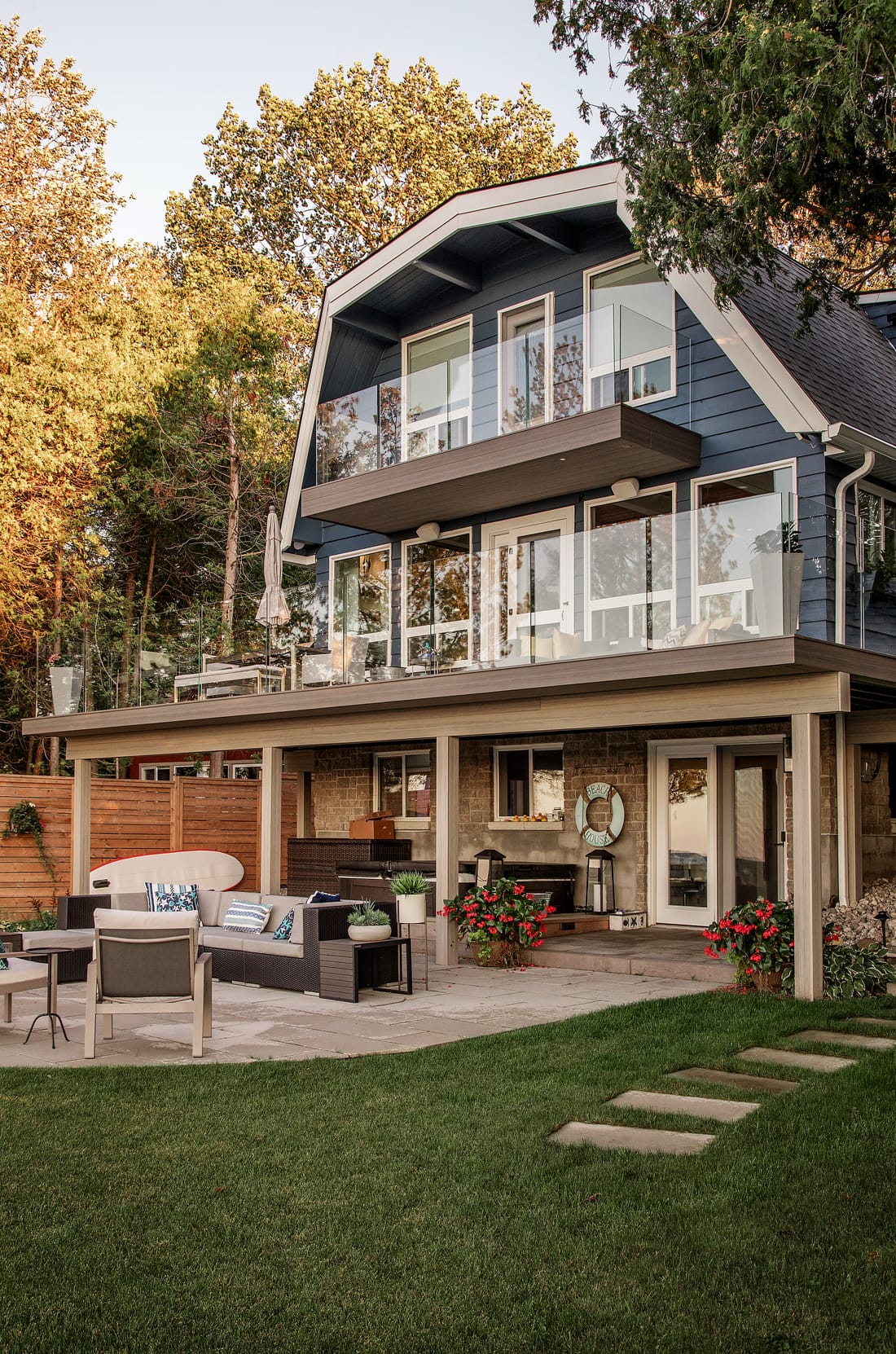 A deck Simcoe Decks built: glass railing upstairs, a covered patio below